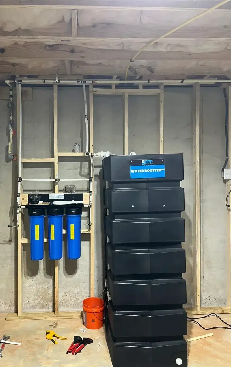 Three-stage whole-home water filtration system installed by The Village Plumber